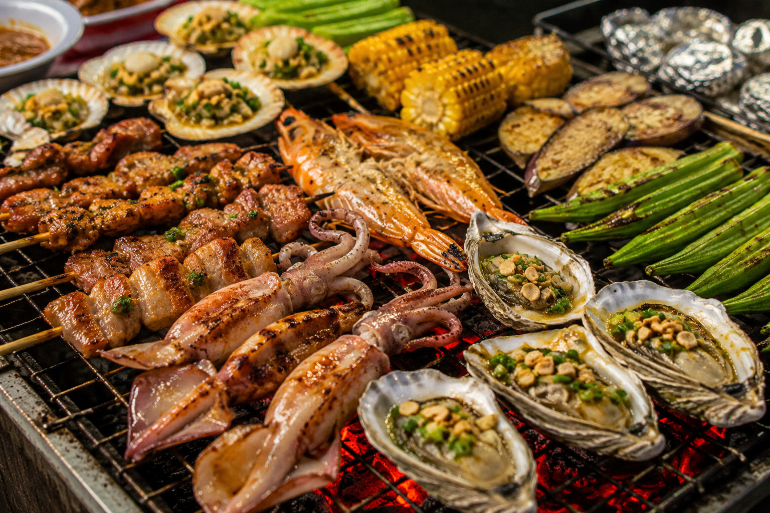 Vietnamese barbecue foods on a charcoal grill