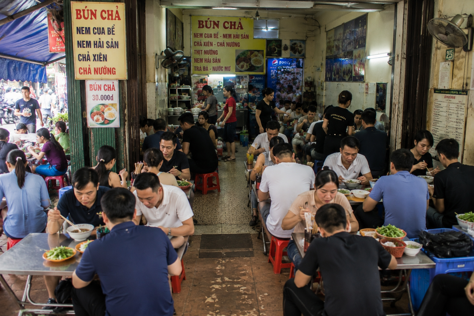 A busy Vietnamese street food restaurant during lunch.