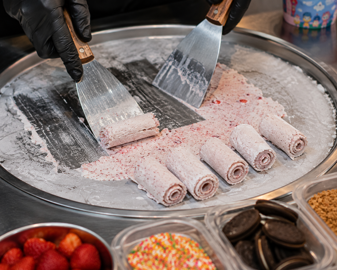 Rolled ice cream being prepared on a cold plate at a Vietnam street food stall