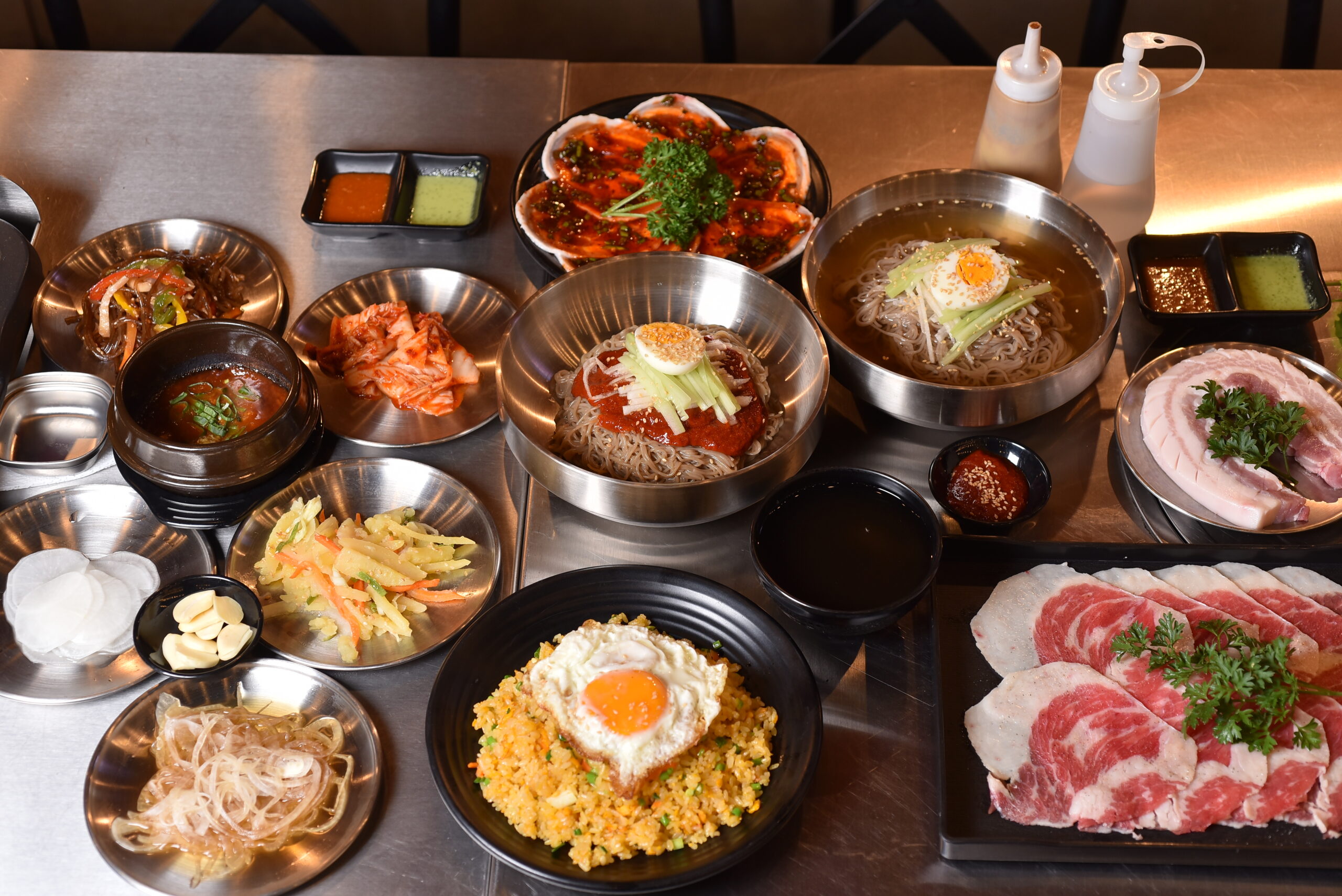 Korean BBQ feast with grilled pork, cold noodles and side dishes at Nướng Rơm in Da Nang