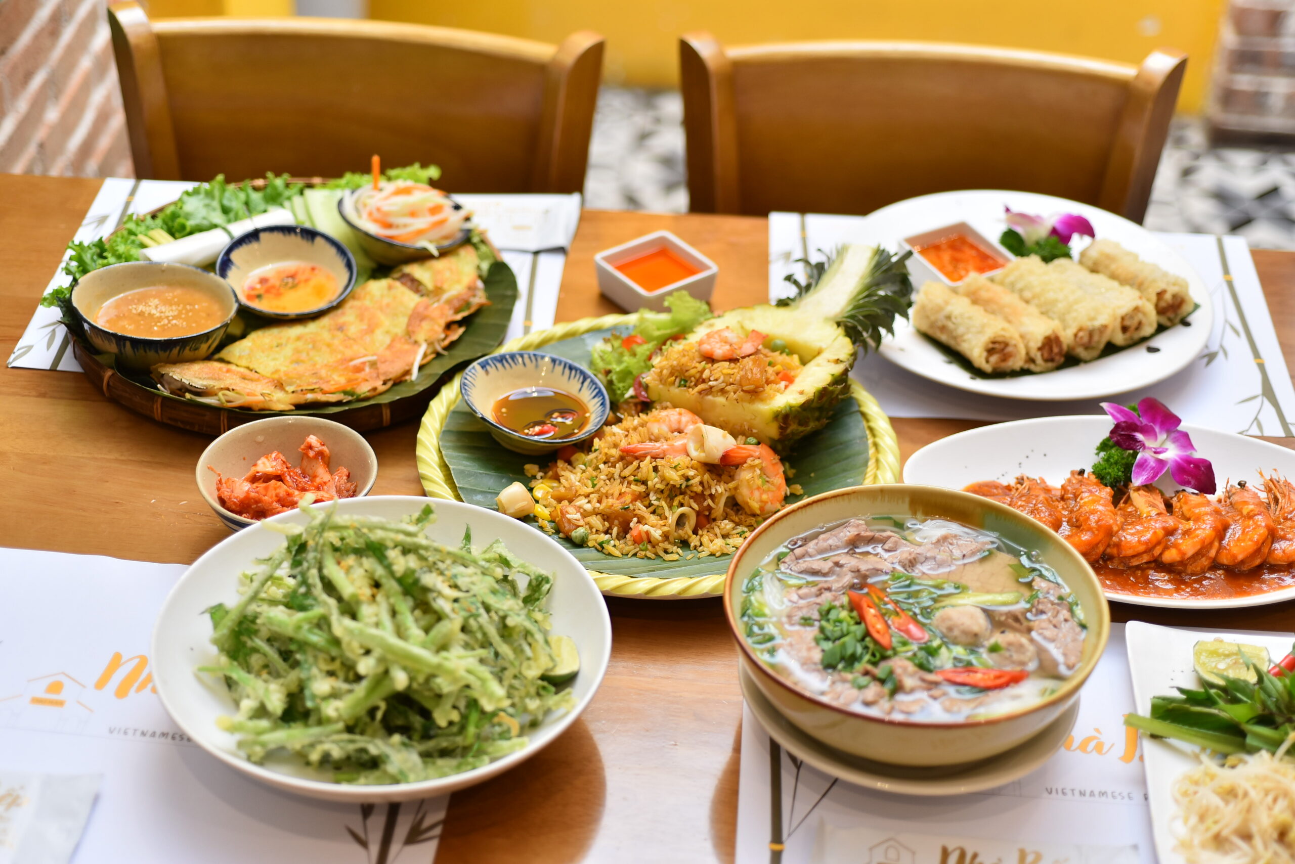 Traditional Vietnamese food spread with Phở, Bánh Xèo and seafood dishes at Nhà Bếp in Da Nang