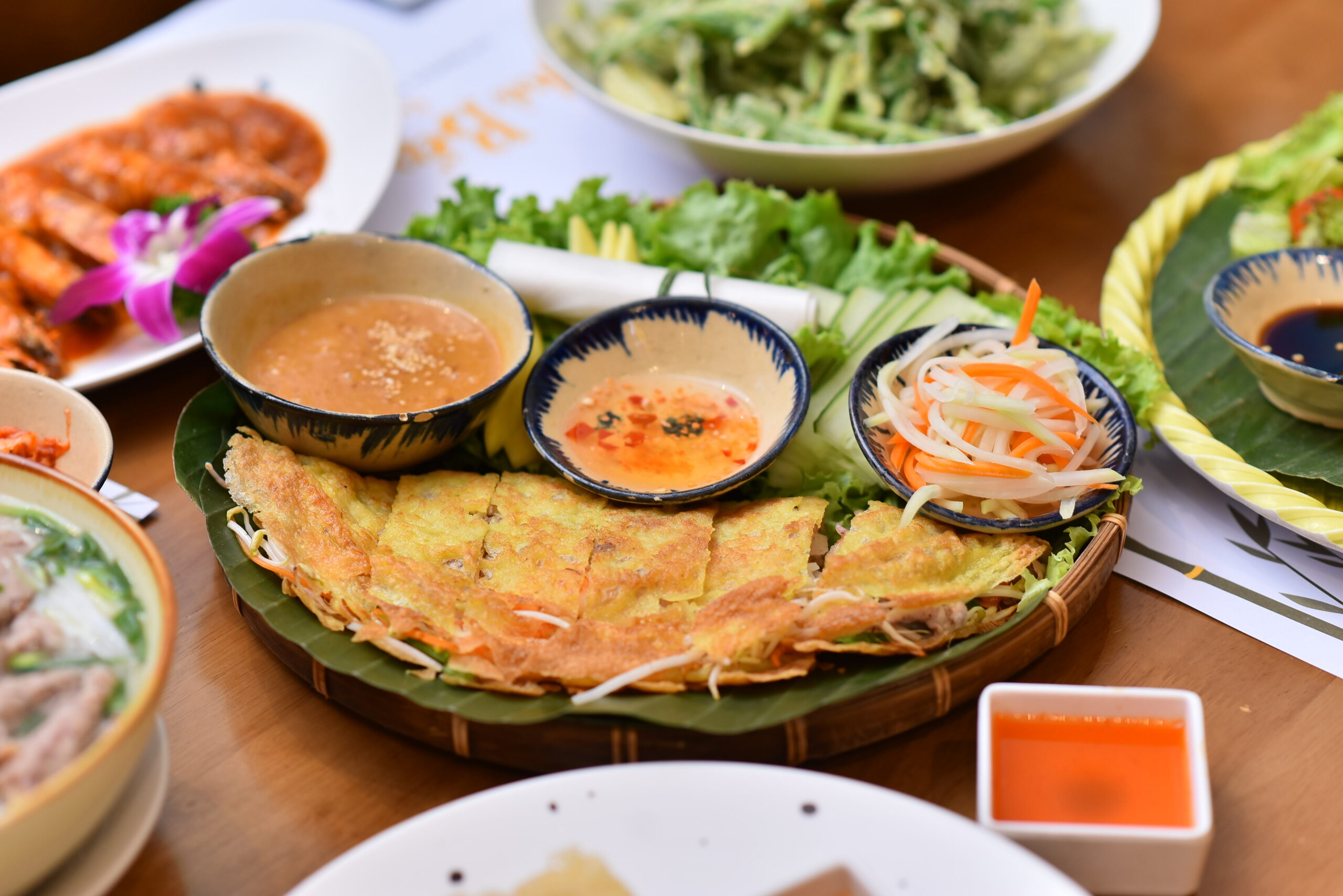 Vietnamese Bánh Xèo served with fresh vegetables and dipping sauces at Nhà Bếp in Da Nang