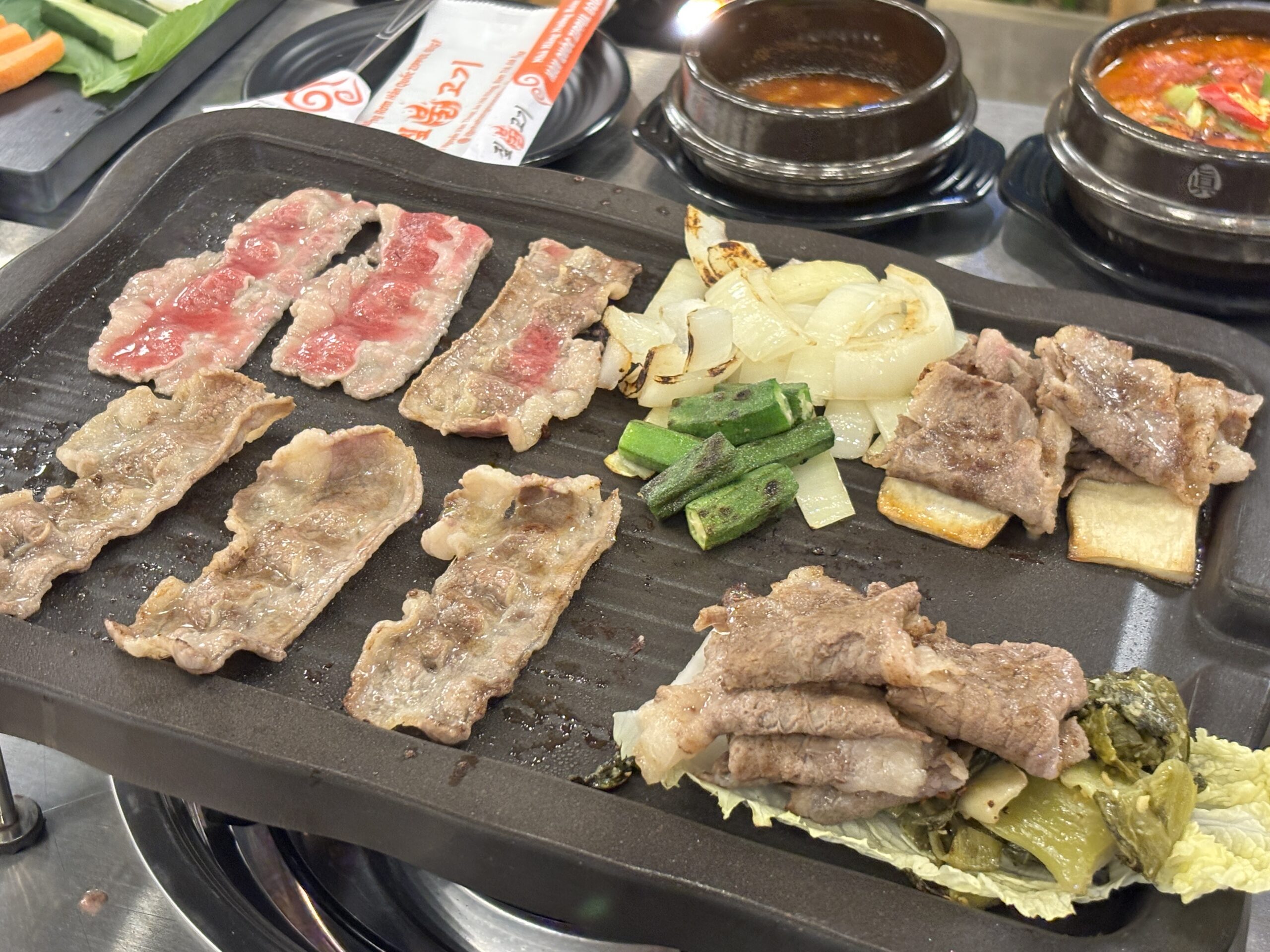 Korean BBQ meat grilling at the table at Nuong Rom Da Nang