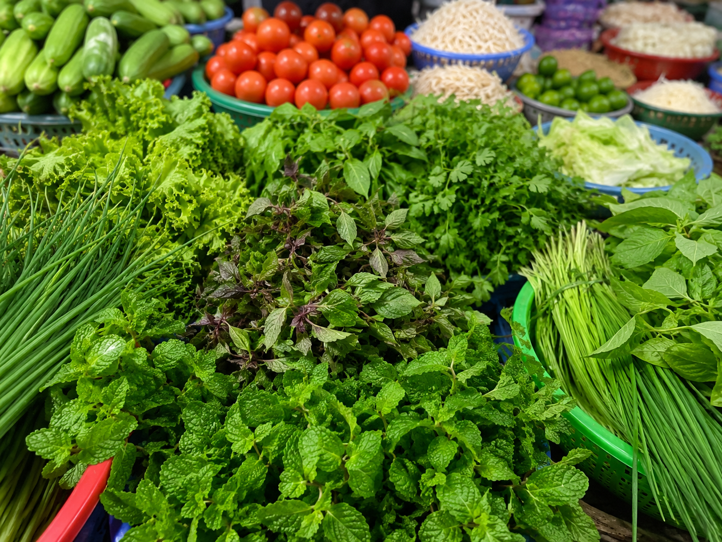 Fresh Vietnamese herbs and vegetables at a local market